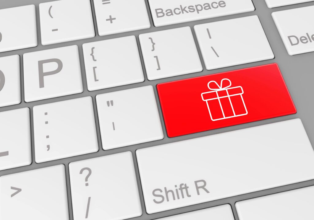 Benefits of computerized appointment scheduling: A special button with a gift box on a laptop keyboard, symbolizing the added value and convenience provided by computerized appointment scheduling.